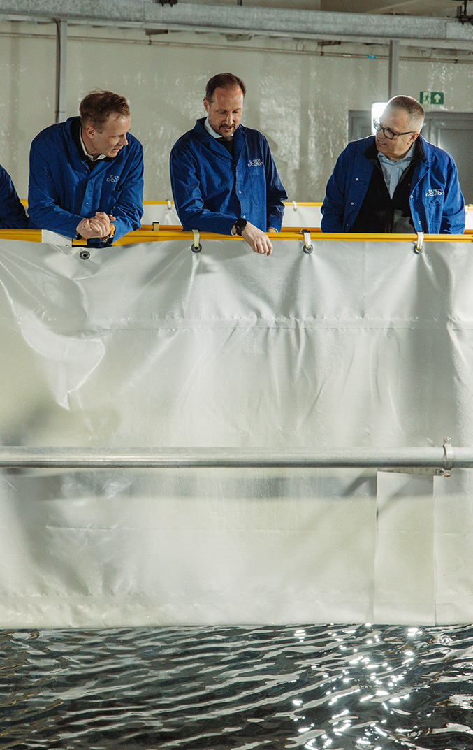 Crown Prince Haakon Magnus overlooking land-based salmon tanks at Salmon Evolution, Indre Harøy. Photo